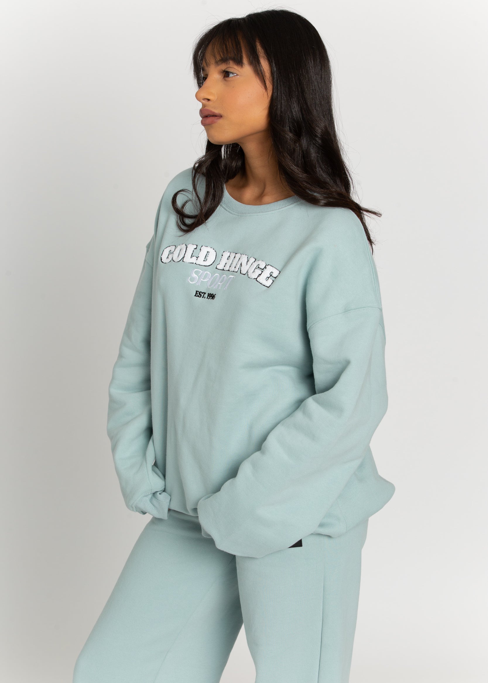 Upgrade your wardrobe with the Iceberg GH Sport Sweatshirt. This cozy piece features fuzzy 3D letters on the front and can be layered with a bold jacket and beanie for chilly weather, or paired with a tennis skirt for the warmer months. Complete the look with the matching sweatpants for a cohesive style.