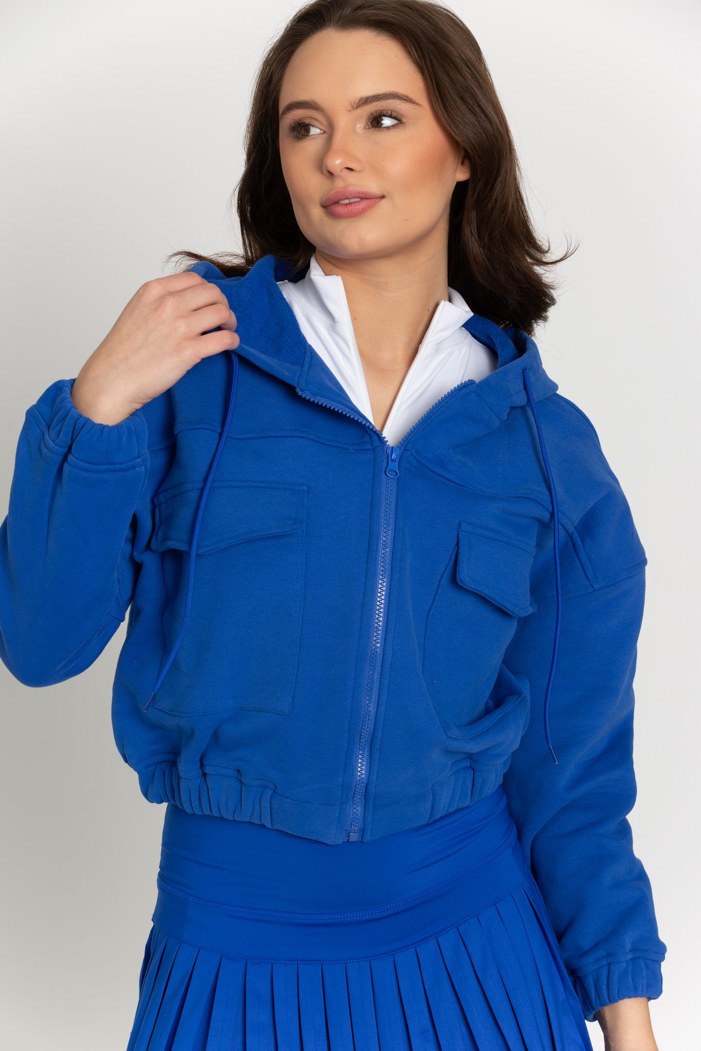 A cobalt blue hoodie jacket made of thick cotton blend with fleece lining. It features two front pockets, a drawstring hood and elastic waist/wrist bands. Stylish and versatile - perfect for any occasion.