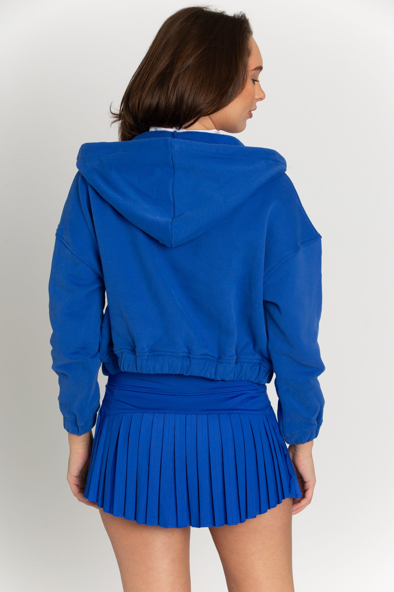 A cobalt blue hoodie jacket made of thick cotton blend with fleece lining. It features two front pockets, a drawstring hood and elastic waist/wrist bands. Stylish and versatile - perfect for any occasion.